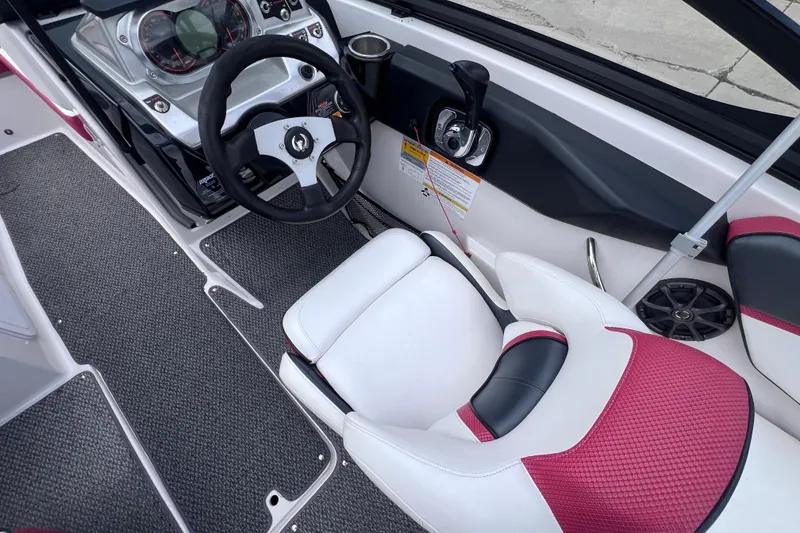Slide: The Image of Interior of a 2014 Scarab 195 H.O. boat with steering wheel and seating. - 11
