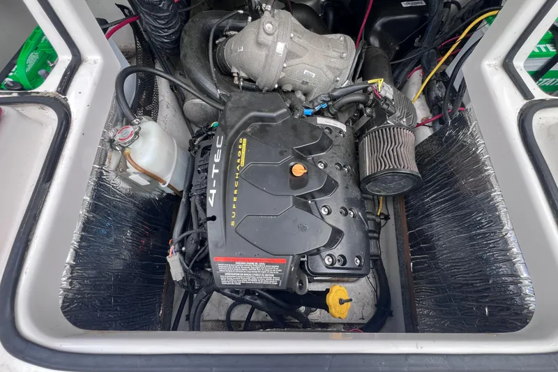 Slide: The Image of Engine compartment of a 2014 Scarab 195 H.O. boat, featuring a 4-TEC supercharged engine. - 13