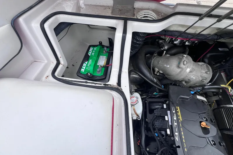 Slide: The Image of Engine compartment of a 2014 Scarab 195 H.O. boat with visible battery and components. - 15