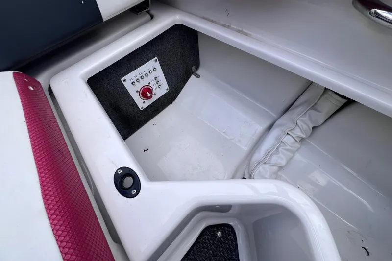 Slide: The Image of Storage compartment in a 2014 Scarab 195 H.O. boat with control panel. - 16