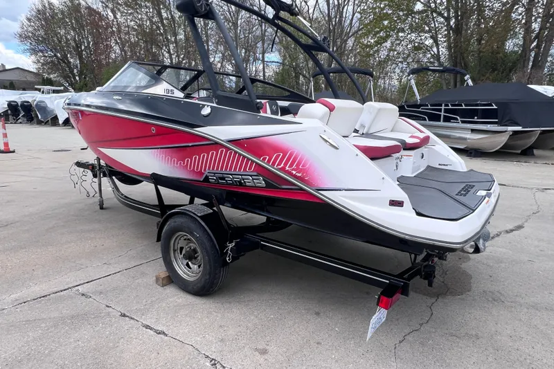 Slide: The Image of 2014 Scarab 195 H.O. boat with red and white design on a trailer. - 4