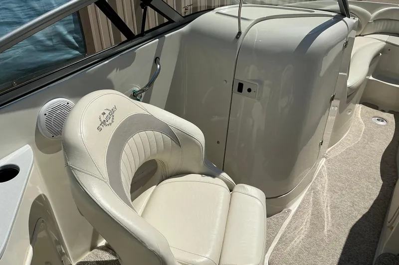 Slide: The Image of Interior of a 2010 Stingray 250 LR boat featuring a comfortable white seat. - 11