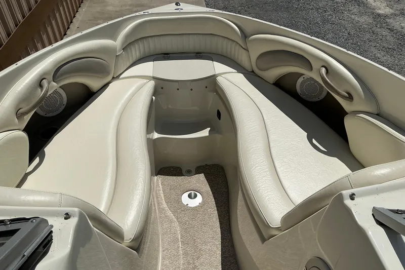 Slide: The Image of 2010 Stingray 250 LR boat interior with beige seating and speakers. - 12