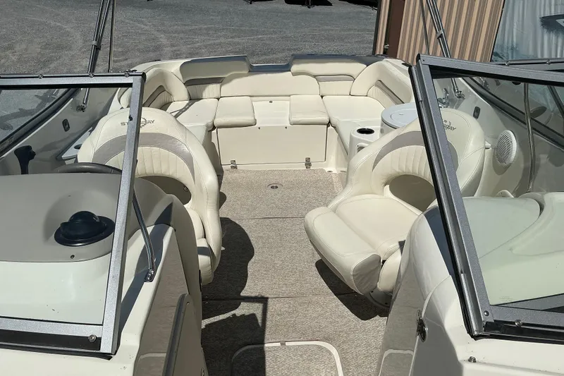 Slide: The Image of Interior view of a 2010 Stingray 250 LR boat with beige seating and carpet. - 13