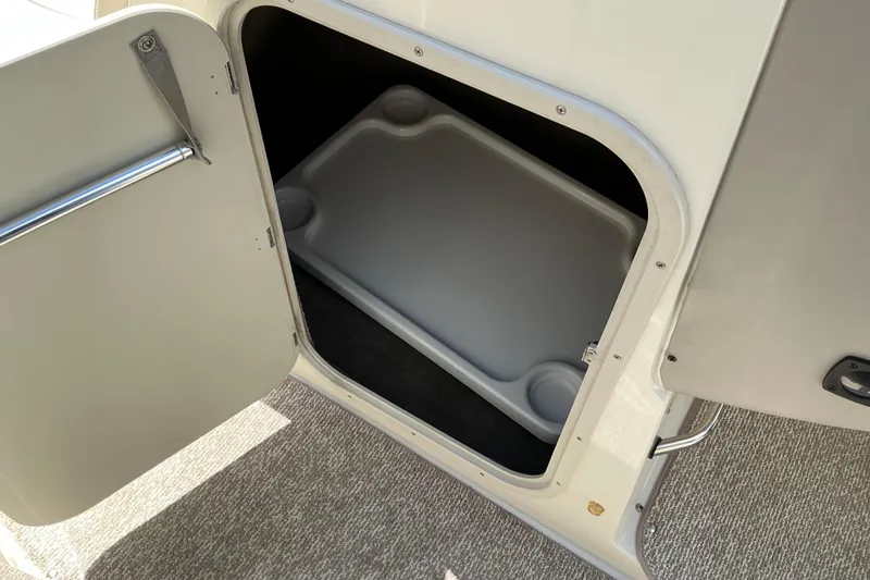 Slide: The Image of Open storage compartment in a 2010 Stingray 250 LR boat interior. - 14