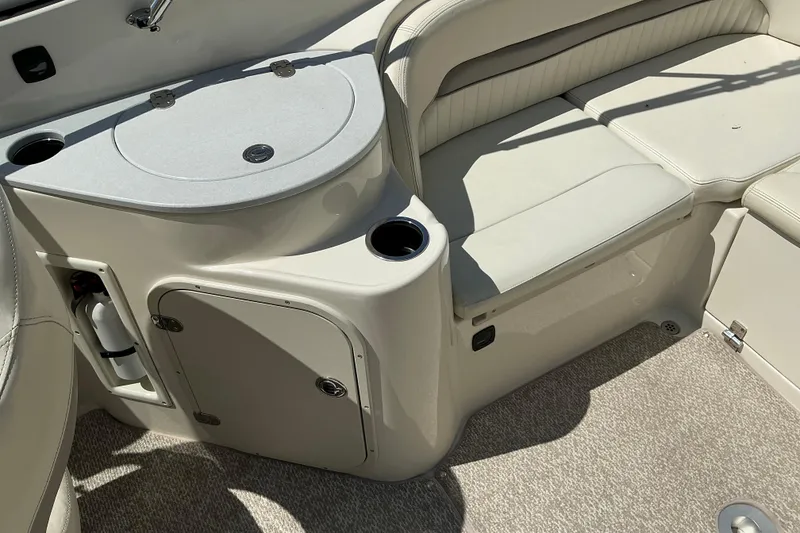 Slide: The Image of Interior of a 2010 Stingray 250 LR boat with seating and storage compartments. - 15