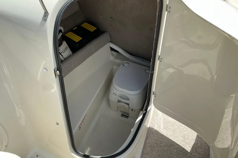 Slide: The Image of Interior view of a 2010 Stingray 250 LR boat with a compact toilet. - 16