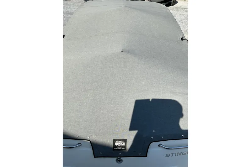 Slide: The Image of 2010 Stingray 250 LR boat with a gray protective cover. - 18