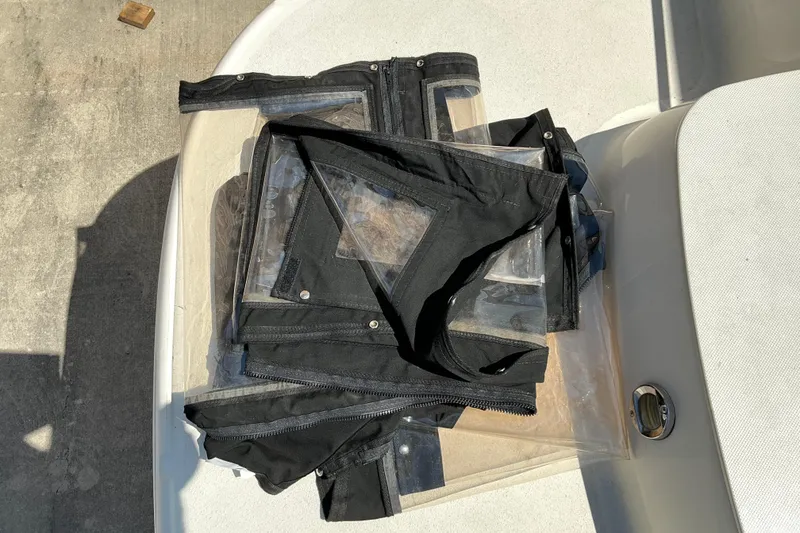 Slide: The Image of Black canvas and clear plastic boat covers on a Stingray 250 LR, 2010 model. - 20