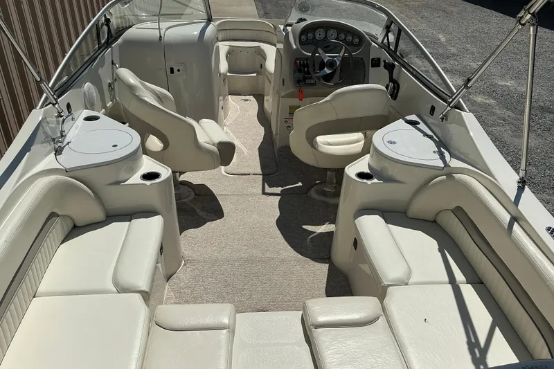 Slide: The Image of 2010 Stingray 250 LR boat interior with white seating and modern dashboard. - 4