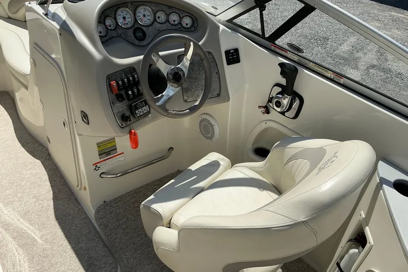 Slide: The Image of Interior of a 2010 Stingray 250 LR boat showing steering wheel and control panel. - 5
