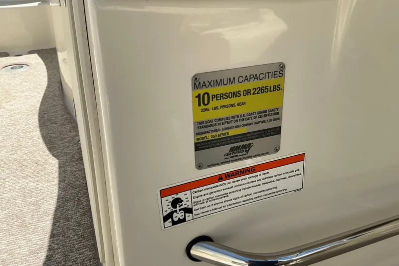Slide: The Image of 2010 Stingray 250 LR boat capacity label, maximum 10 persons or 2265 lbs, safety warning included. - 6