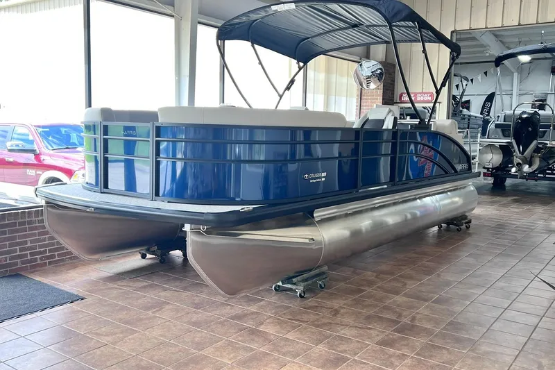 The Image of 2026 Harris Cruiser 210 SLDH pontoon boat displayed indoors on tiled floor. - 0
