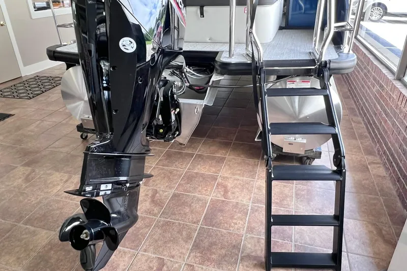 Slide: The Image of 2026 Harris Cruiser 210 SLDH boat with motor and boarding ladder in showroom. - 11