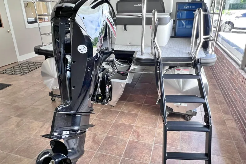 Slide: The Image of 2026 Harris Cruiser 210 SLDH pontoon boat with outboard motor and boarding ladder. - 12