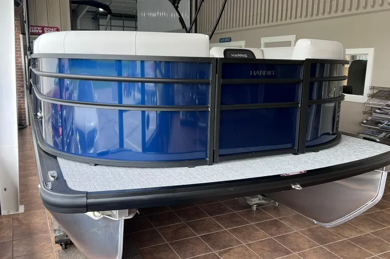 Slide: The Image of 2026 Harris Cruiser 210 SLDH pontoon boat with sleek blue exterior in showroom. - 3