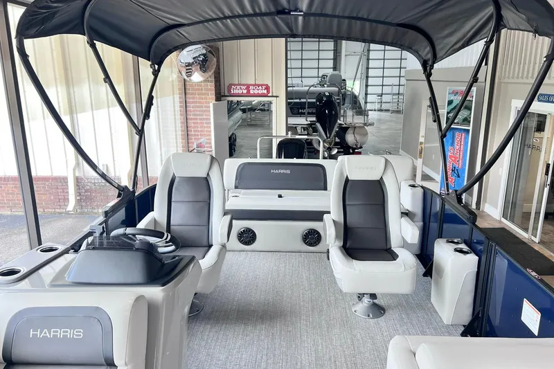 Slide: The Image of 2026 Harris Cruiser 210 SLDH pontoon boat interior with seating and canopy in showroom. - 4
