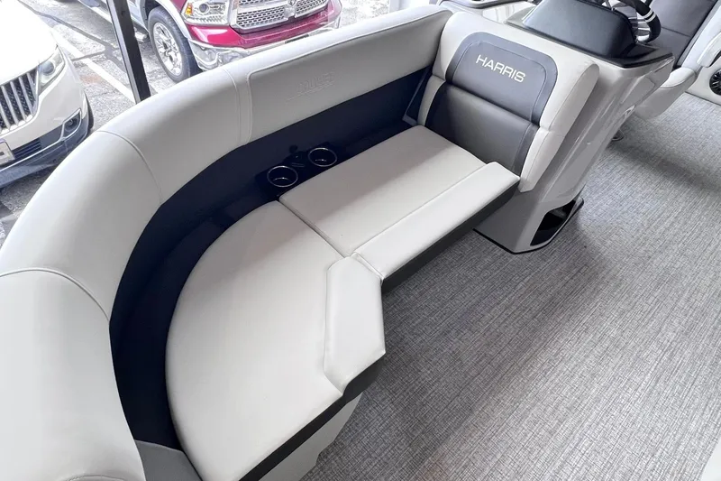 Slide: The Image of 2026 Harris Cruiser 210 SLDH boat interior with plush seating and cup holders. - 7