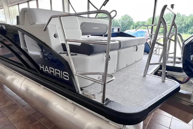 Slide: The Image of 2026 Harris Cruiser 210 SLDH pontoon boat with sleek seating and stainless steel railings. - 9
