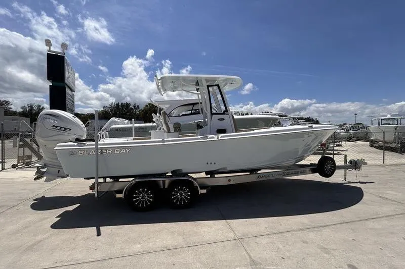 The Image of 2026 Blazer Bay Makaira 2800 boat on trailer under clear blue sky. - 0
