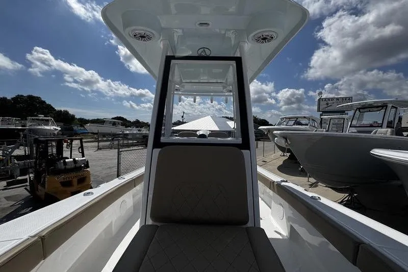 Slide: The Image of 2026 Blazer Bay Makaira 2800 boat interior with clear sky and docked vessels. - 10