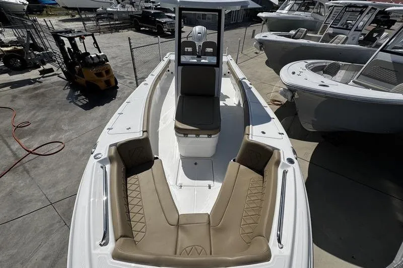 Slide: The Image of 2026 Blazer Bay Makaira 2800 boat with tan seating, docked at a marina. - 15