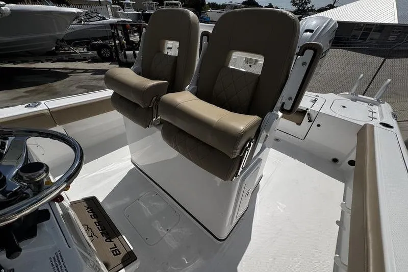 Slide: The Image of 2026 Blazer Bay Makaira 2800 boat interior with dual cushioned seats and steering console. - 16