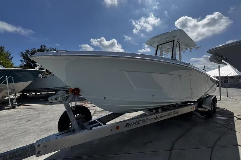 Slide: The Image of 2026 Blazer Bay Makaira 2800 boat on trailer under blue sky. - 2