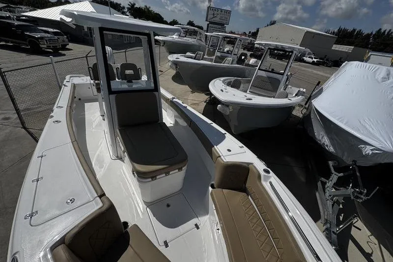 Slide: The Image of 2026 Blazer Bay Makaira 2800 boat with sleek design and spacious seating at a dealership. - 23