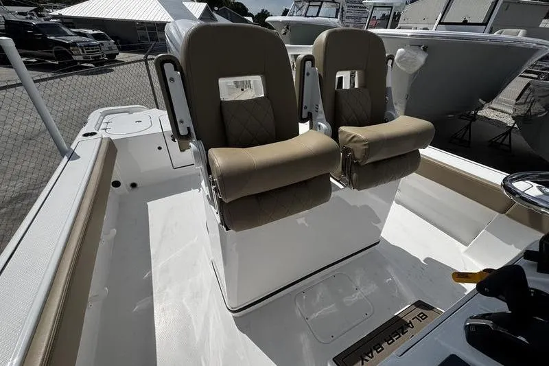 Slide: The Image of 2026 Blazer Bay Makaira 2800 boat interior with dual tan seats and steering console. - 28