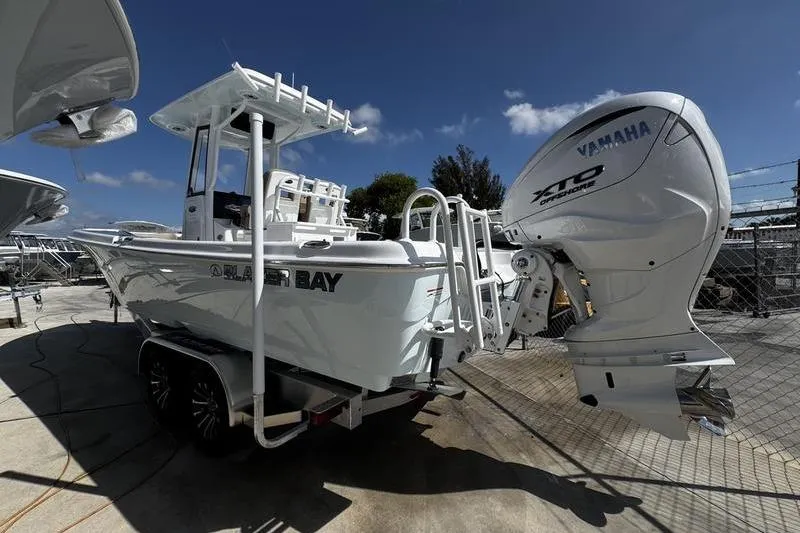 Slide: The Image of 2026 Blazer Bay Makaira 2800 boat with Yamaha engine on trailer, outdoor setting. - 4