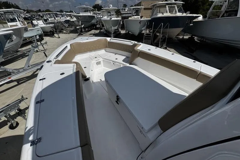 Slide: The Image of 2026 Blazer Bay Makaira 2800 boat interior with seating and storage, displayed at a marina. - 7