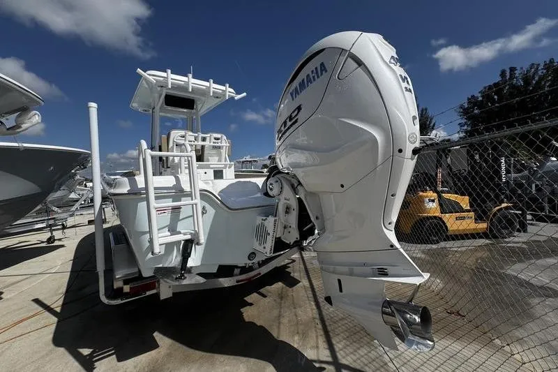 Slide: The Image of 2026 Blazer Bay Makaira 2800 boat with Yamaha outboard motor, parked outdoors. - 8