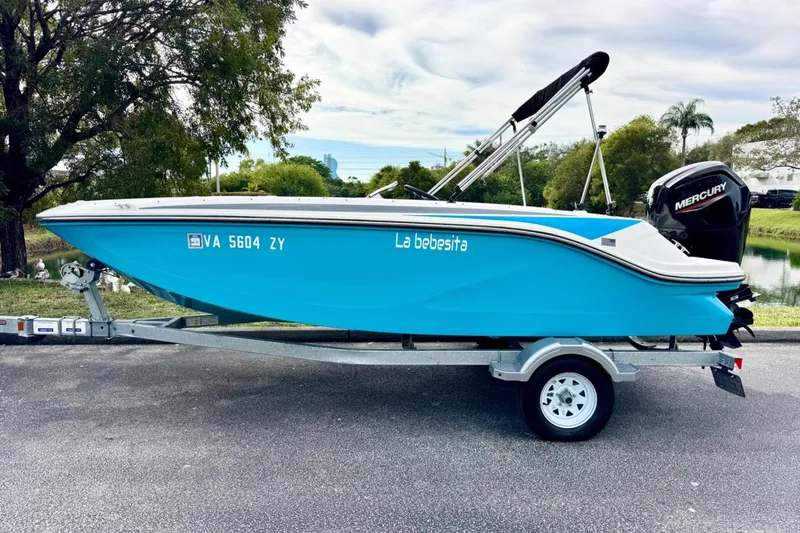 The Image of 2022 Bayliner Element M17 boat on trailer, blue hull, Mercury outboard motor. - 0