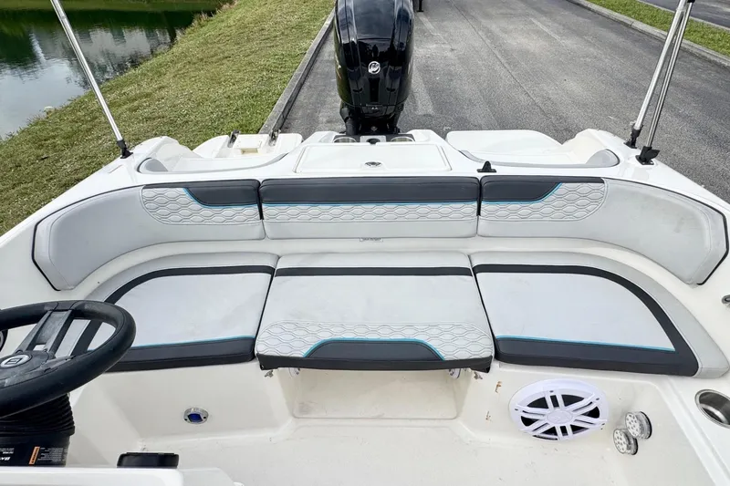 Slide: The Image of 2022 Bayliner Element M17 boat interior with cushioned seating and steering wheel. - 12