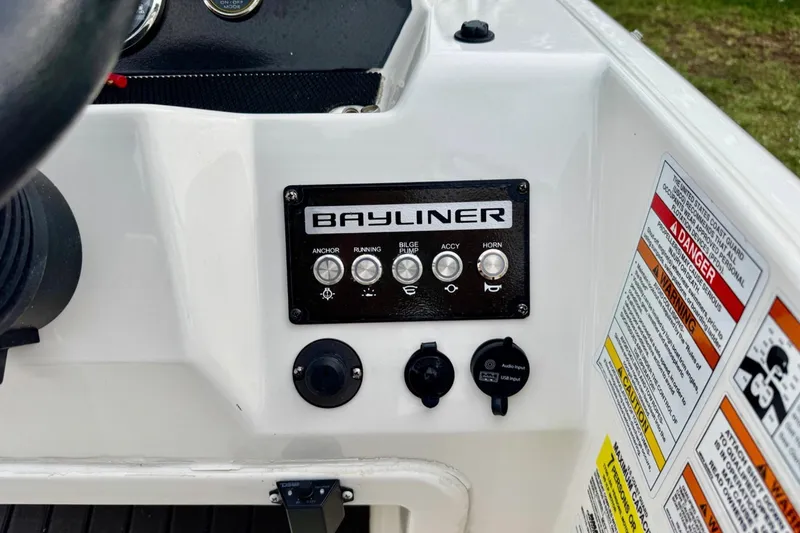 Slide: The Image of Control panel of 2022 Bayliner Element M17 boat with labeled switches and warnings. - 14