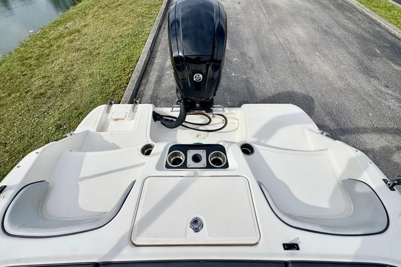 Slide: The Image of 2022 Bayliner Element M17 boat stern view with motor and seating area. - 17