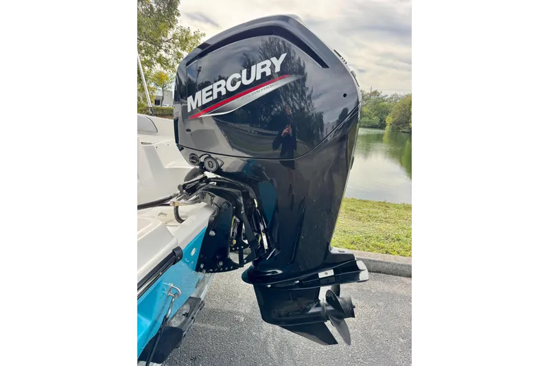 Slide: The Image of Outboard motor on 2022 Bayliner Element M17 boat by a lake. - 19