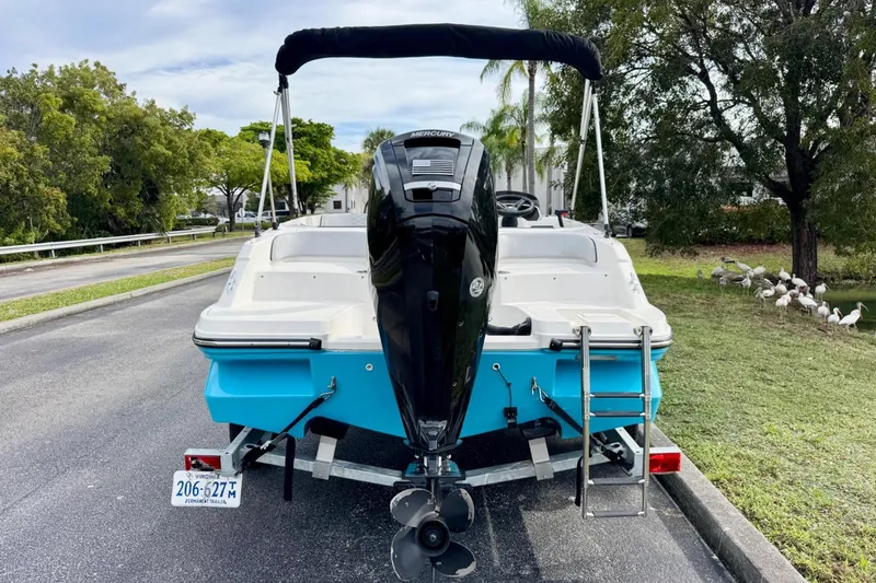 Slide: The Image of 2022 Bayliner Element M17 boat on trailer, rear view with outboard motor and ladder. - 3