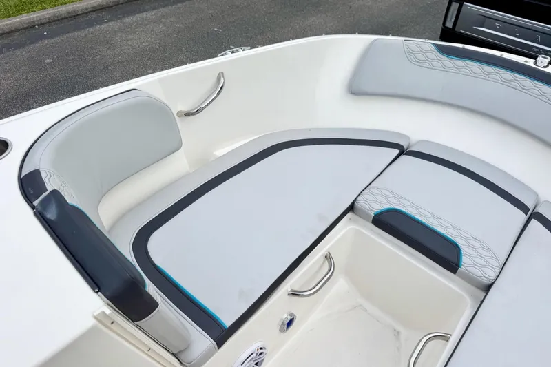 Slide: The Image of 2022 Bayliner Element M17 boat interior with cushioned seating and storage area. - 9
