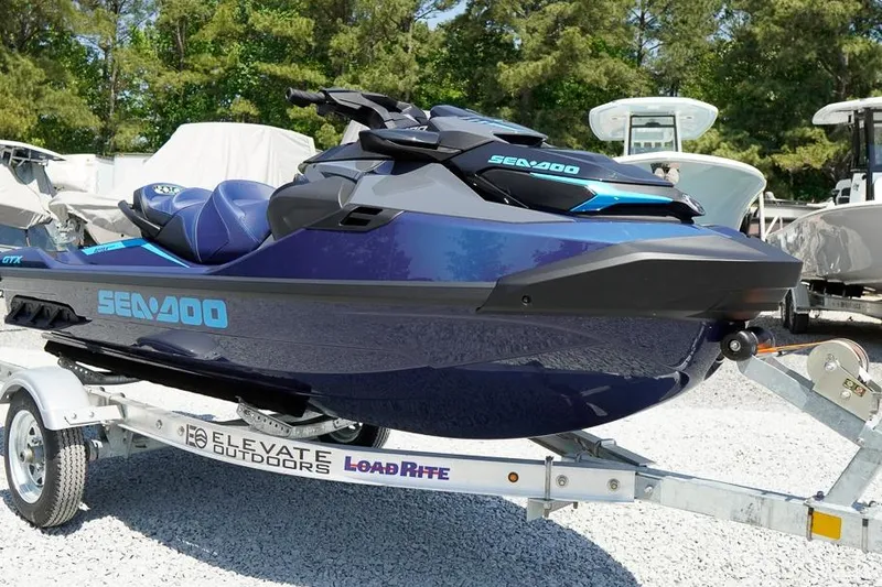 The Image of 2026 Sea-Doo GTX 170 jet ski on trailer, parked outdoors. - 1