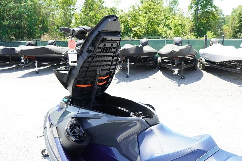 Slide: The Image of 2026 Sea-Doo GTX 170 with open storage compartment, parked outdoors. - 22