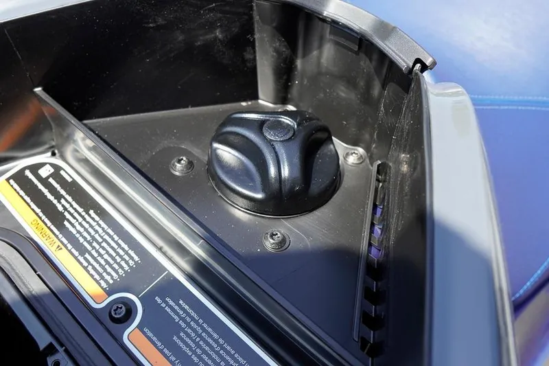 Slide: The Image of 2026 Sea-Doo GTX 170 storage compartment with secure latch and warning label. - 25