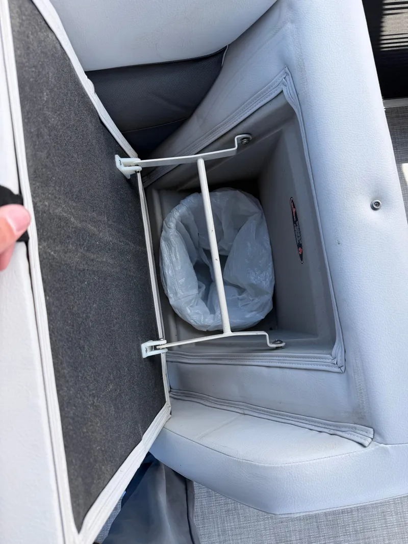 Slide: The Image of Trash bin in seat of Harris 230 Cruiser CWDH 2021 boat. - 11