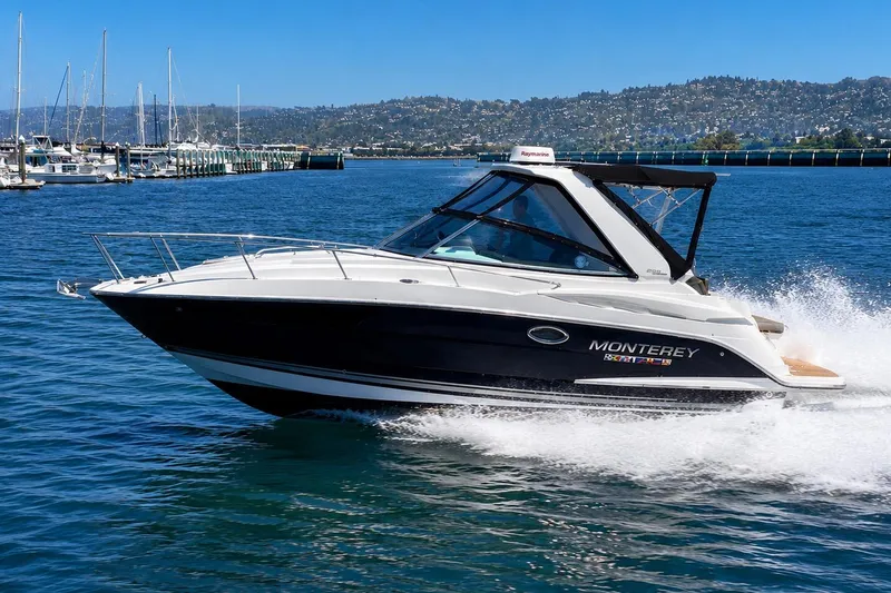 The Image of 2019 Monterey 295 Sport Yacht cruising on a sunny day in a scenic harbor. - 0