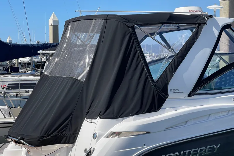 Slide: The Image of 2019 Monterey 295 Sport Yacht with black canvas cover at marina. - 10