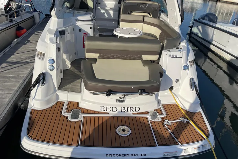 Slide: The Image of 2019 Monterey 295 Sport Yacht docked, featuring spacious seating and elegant wood finish. - 11