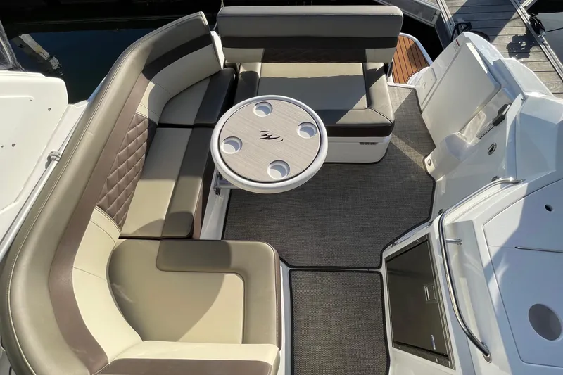 Slide: The Image of 2019 Monterey 295 Sport Yacht interior with elegant seating and round table on deck. - 14