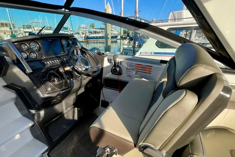 Slide: The Image of Cockpit of 2019 Monterey 295 Sport Yacht with modern controls and steering wheel. - 15