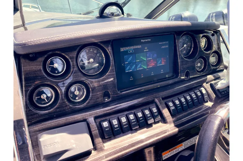 Slide: The Image of Dashboard of a 2019 Monterey 295 Sport Yacht with navigation controls and gauges. - 16